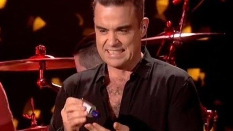 Robbie Williams se desinfecta las manos con cara de 'asco' tras tocar a sus fans