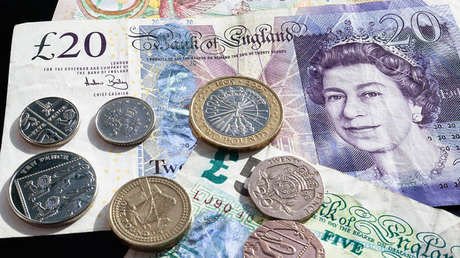 Un estudiante de Cambridge quema un billete ante un sintecho