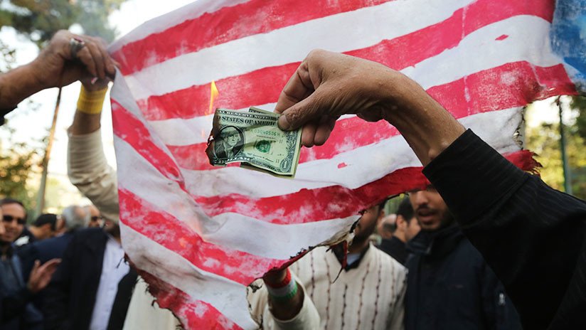 Manifestantes iraníes queman dólares y banderas de EE.UU. por la reanudación de las sanciones