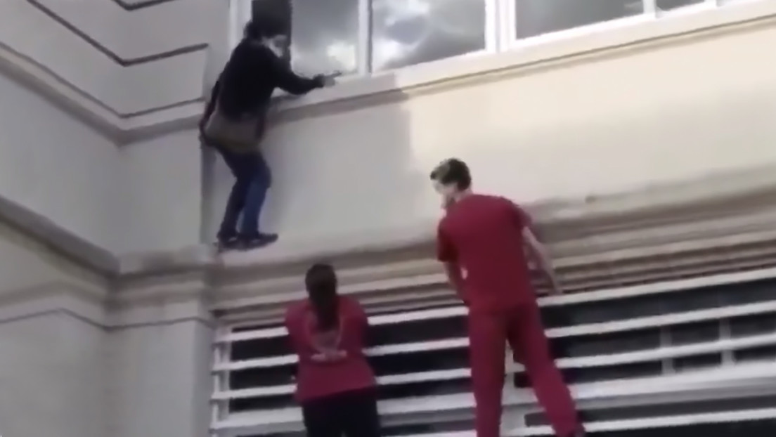 VIDEO: Una 'mujer araña' escala por las paredes de un hospital para ver a un familiar con covid-19 y es rescatada por la Policía