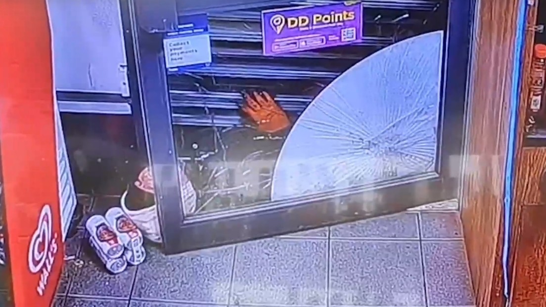 Ladrón queda atrapado bajo las persianas de una tienda y se bebe una cerveza mientras espera a la Policía (VIDEO)