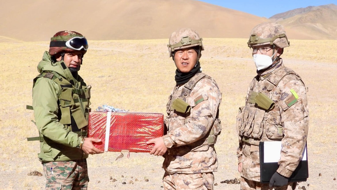 Indian and Chinese soldiers exchange sweets as part of overcoming the border conflict