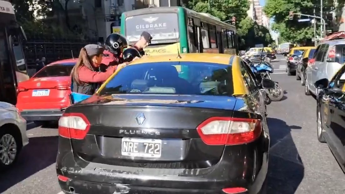 Conductor se duerme en plena avenida y policías de Argentina sacuden un taxi para despertarlo