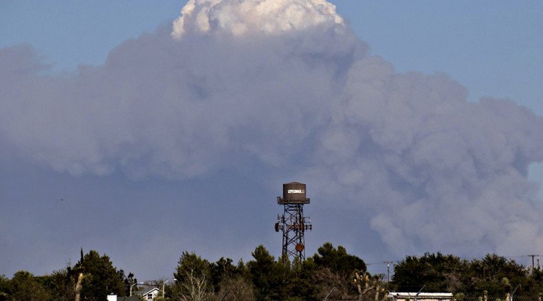 Cars ablaze as 3,500-acre California brush fire swallows freeway, homes
