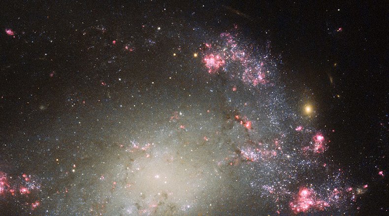 Hubble telescope captures cosmic 'fireworks' from barred spiral galaxy 