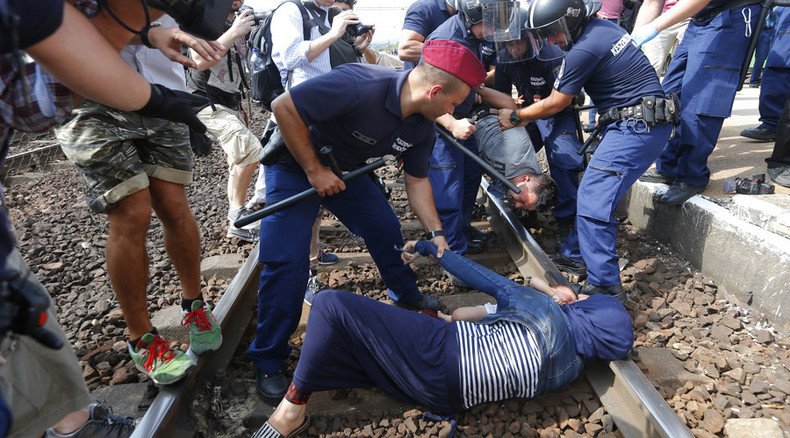 Hungarian police remove desperate refugee family protesting on rail tracks (VIDEO)