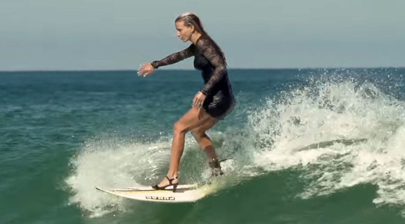 Cowabunga! French surfer rides waves in high heels & cocktail dress (VIDEO)