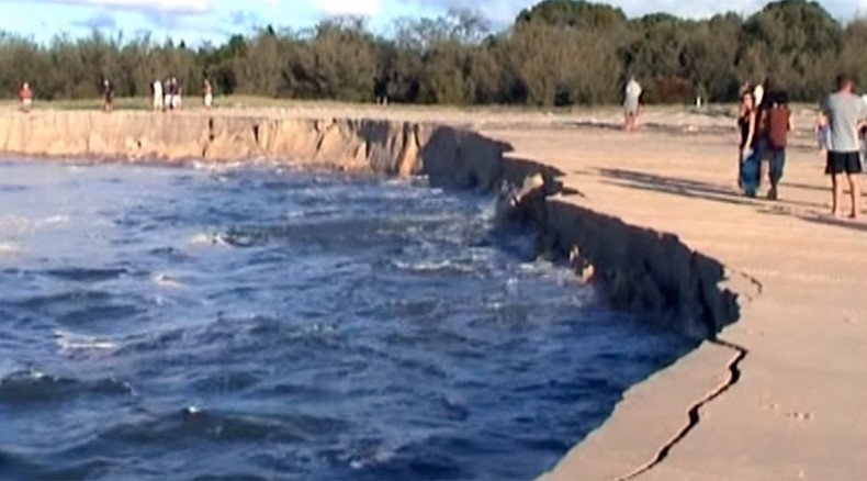 Monstrous sinkhole swallows car, caravan & trailer on Queensland beach