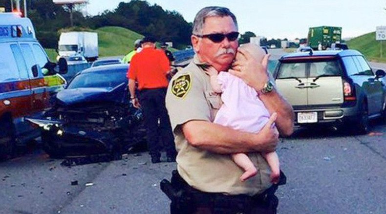 Deputy comforts baby at scene of car crash, photo goes viral