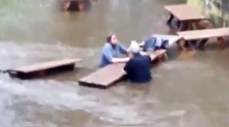 Wet your whistle: Hardy Yorkshire drinkers defy rising floodwaters to enjoy pint