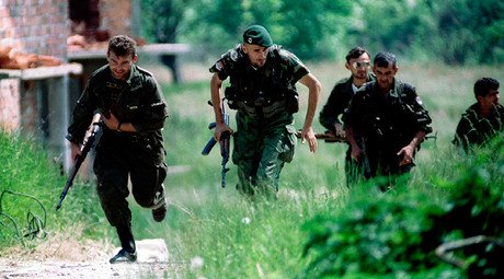 ARCHIVE PHOTO: Bosnian Serb soldiers run for cover during an operation near the northern Bosnian town of Brcko on the corridor connecting northern Bosnia with Serbia © Str