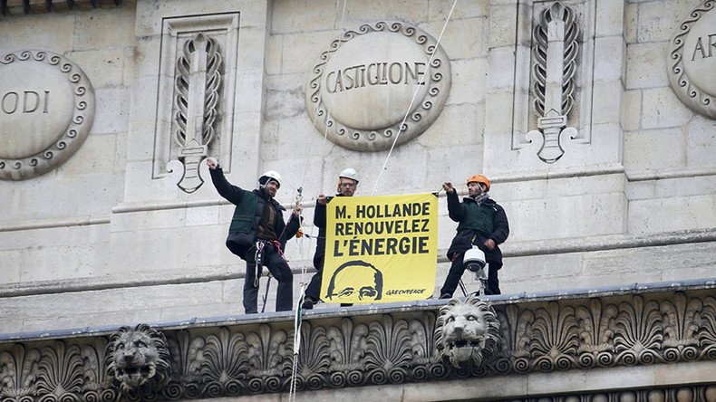 Paint it yellow: 30 Greenpeace activists scale Arc de Triomphe in renewable energy protest (IMAGES)