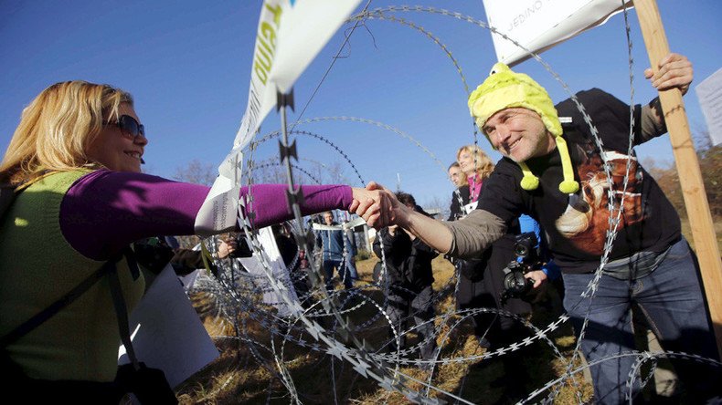 Bump, set, spiked fence: Protesters play volleyball over Slovenia's anti-refugee barrier