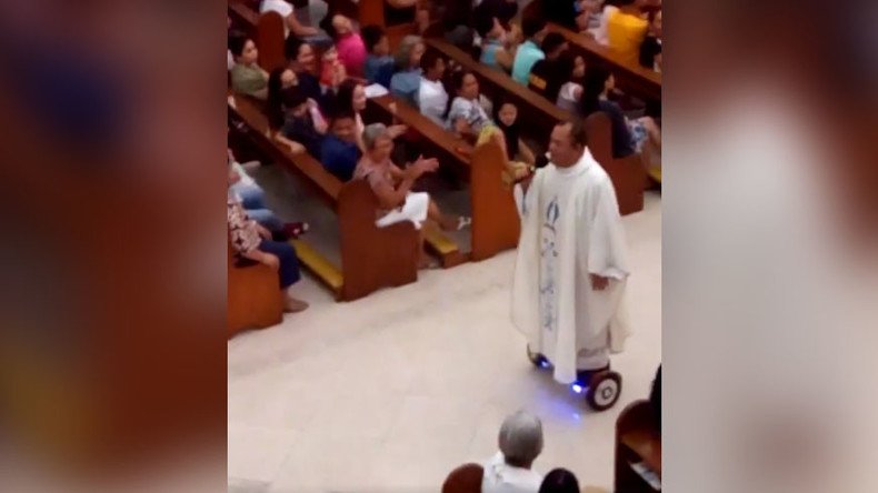 Filipino priest grounded by Church for gliding on hoverboard during mass (VIDEO)