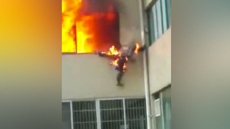 Firefighter in flames jumps out of window in Chinese apartment inferno (VIDEO)