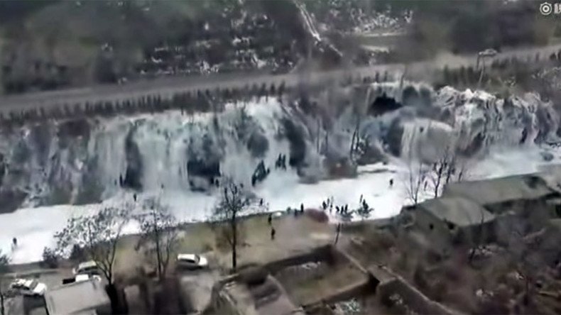 Elsa’s dream: Frozen waterfall the width of football pitch captured in China (VIDEO)