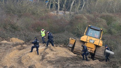 Bulldozers pull down Calais Jungle as authorities relocate migrants to container camp