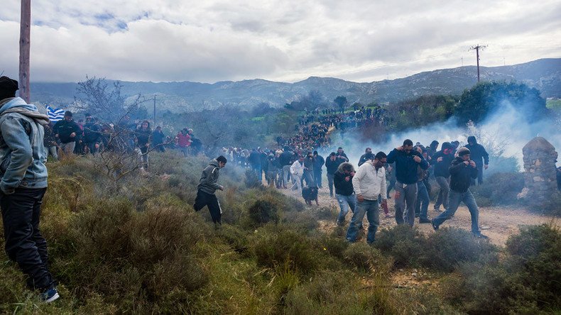 Greek police fire tear gas at rally protesting construction of refugee center on tourist island 