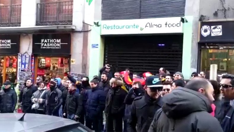Two Madrid security chiefs hide from angry protesters who chase them into bar (VIDEO)