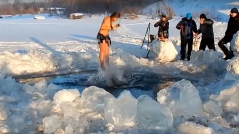 Siberian daredevil bungee jumper plunges into icy river on rope attached to skin by hooks (VIDEO)