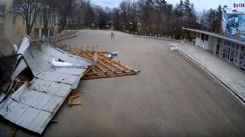 Miracle escape: Roof blown off building lands dangerously close to woman & child (VIDEO)