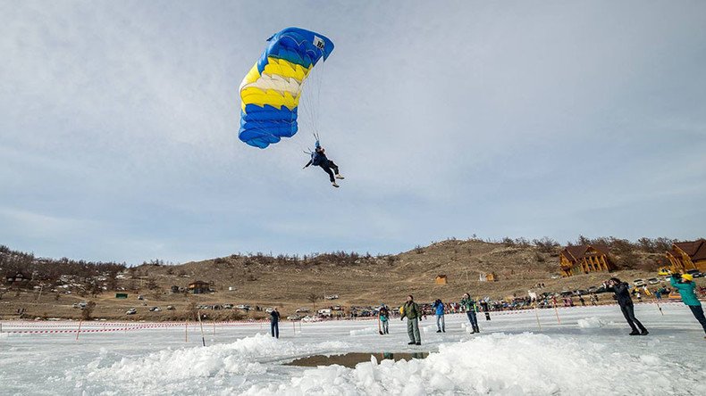 ‘Historic stunt’: Russian daredevils brolly-hop from plane wing into Baikal ice-hole (VIDEO)