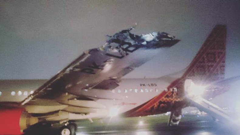 Wing & tail ripped off as 2 planes collide on takeoff in Indonesia (PHOTOS, VIDEO)