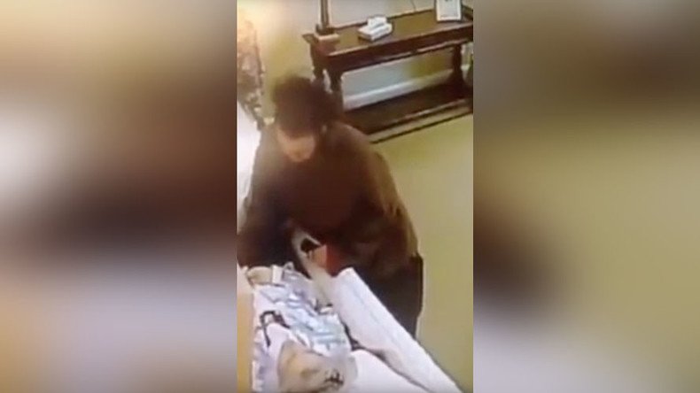 Dead wrong: Thief caught on camera stealing from corpse in casket