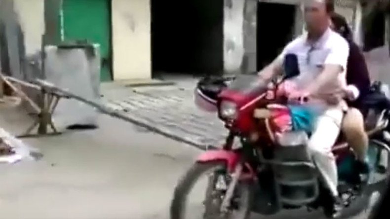 Blind luck: Sightless Chinese man drives motorbike as wife gives directions (VIDEO)