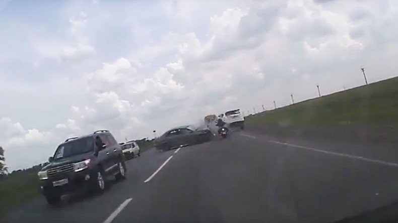 Very narrow escape: Lucky motorcyclist rides straight through car collision (VIDEO)
