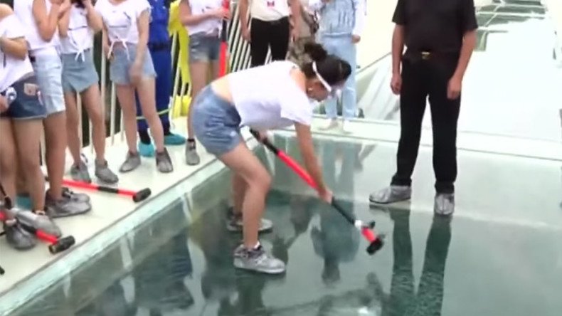 Daredevil volunteers test glass bridge safety in China - with sledgehammers (VIDEO)