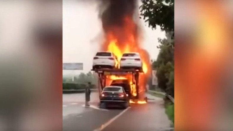 Driver reverses new car off of blazing transporter (VIDEO)