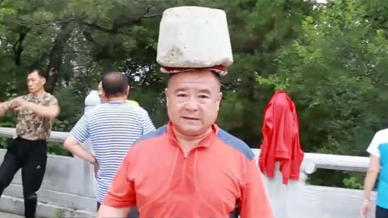 Ready to rock: Chinese man sheds 66lbs by carrying boulder on head (VIDEO)