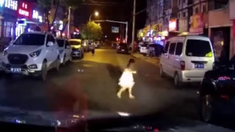 Young girl hit by car after running across road, walks away uninjured (SHOCKING VIDEO)