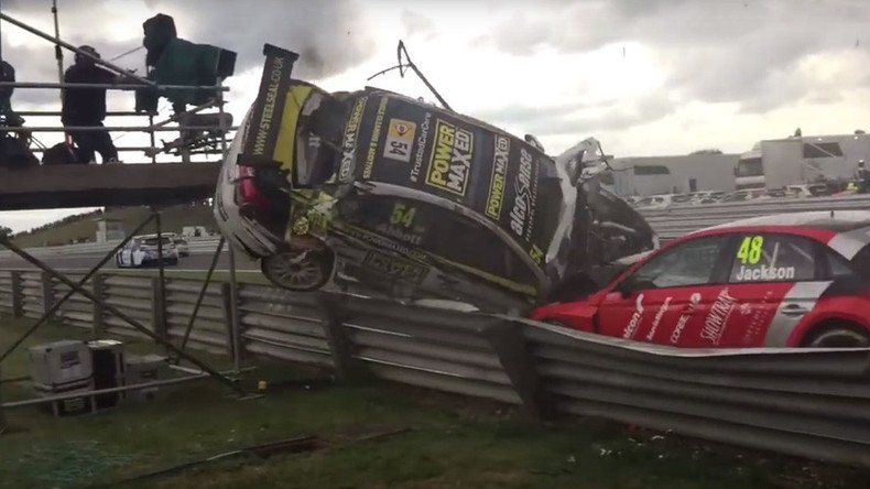Sportscar plunges into TV camera tower at race (VIDEO)
