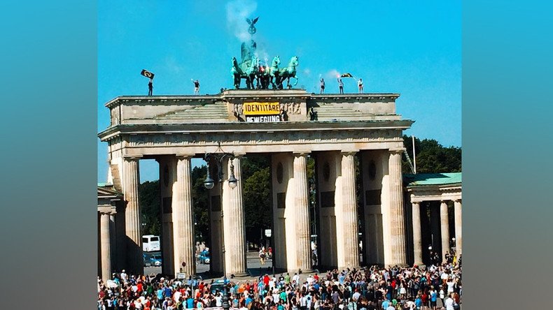 ‘Fortress Europe’: Anti-refugee activists climb Brandenburg Gate to oppose ‘rampant’ immigration
