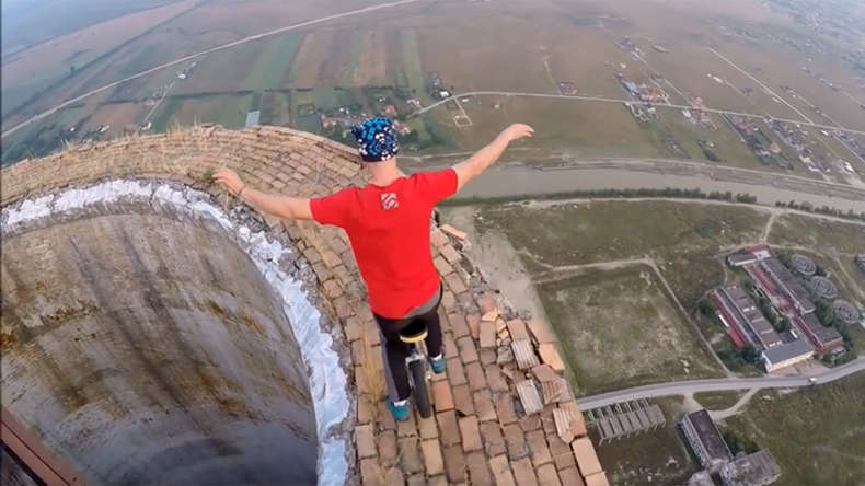 Unicyclist defies death with towering chimney balancing act (VIDEO)