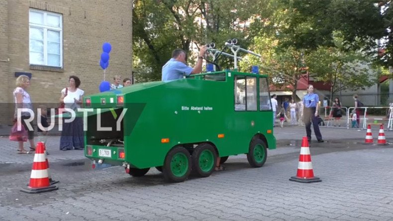 Kids invited to use toy water cannon ‘to feel like real policemen’ at Berlin festival