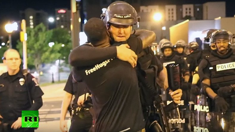 ‘We’re all human’: Charlotte activist hugs riot police (VIDEO)