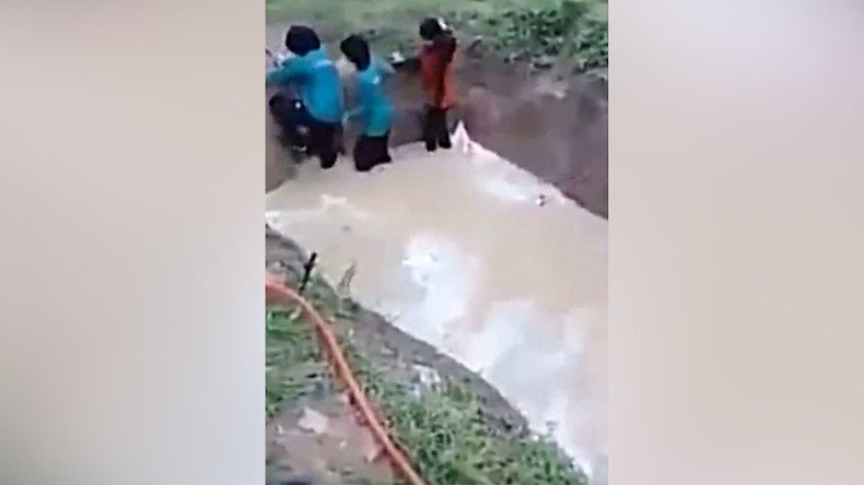 Malaysian schoolgirls forced to walk through muddy snake pit for 'team building' exercise (VIDEO)