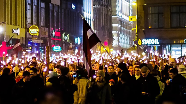 ‘We are Latvians!’ 1,000s join far-right torchlight procession in Riga