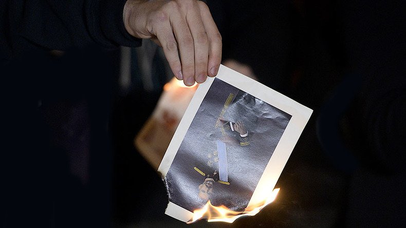 Catalan pro-independence activists arrested after burning photos of King Felipe 