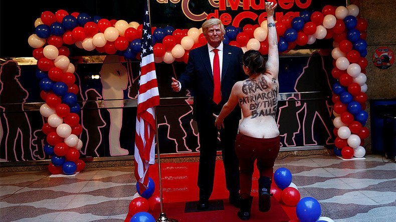 Topless FEMEN protester grabs Trump statue by crotch in Madrid