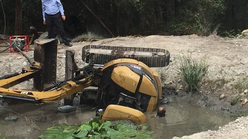 Gasping for air: Man trapped beneath digger in mud-filled dam fights for life (PHOTOS)