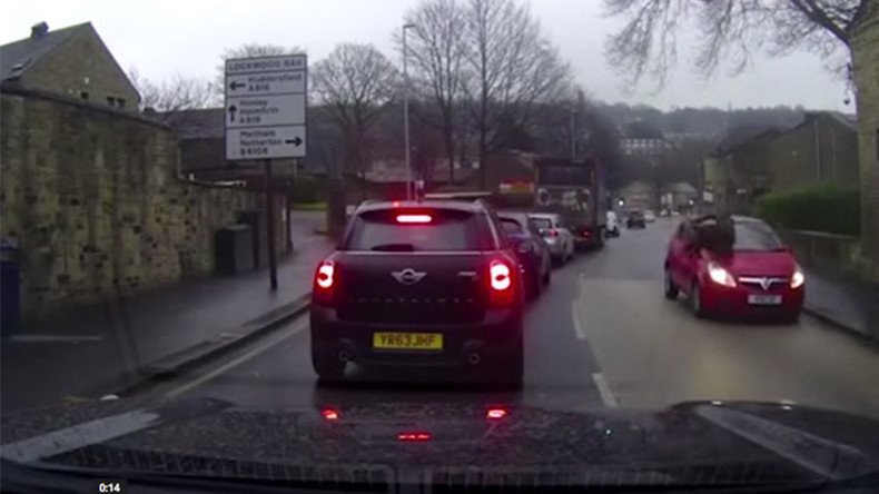 Pedestrian throws himself at passing car… blames the driver (VIDEO)
