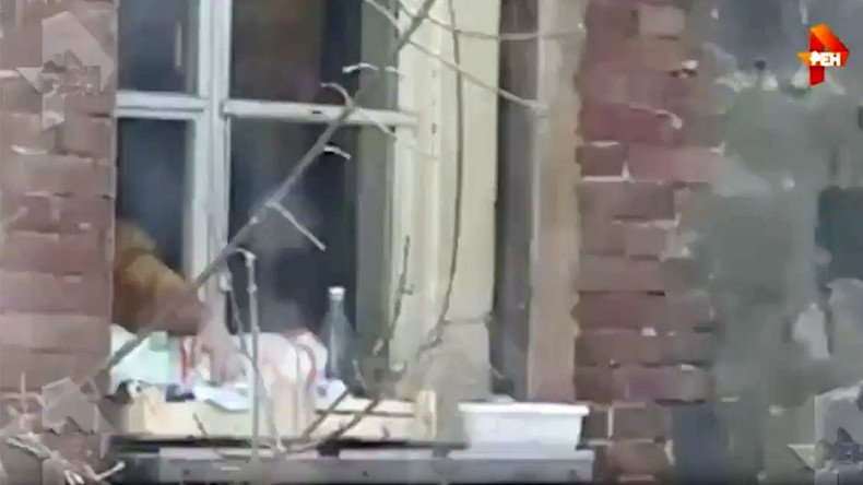 Woman questioned for hanging baby outside window, says she walks her child as she likes