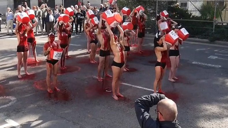 Horned activists soak themselves in ‘blood’ to protest bullfighting in Spain