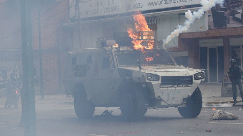 Armored vehicle set on fire plows through crowd in Venezuela (VIDEO)