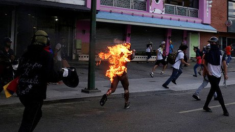 ‘They told me to die & threw a Molotov at me’ – protester on Venezuela riots