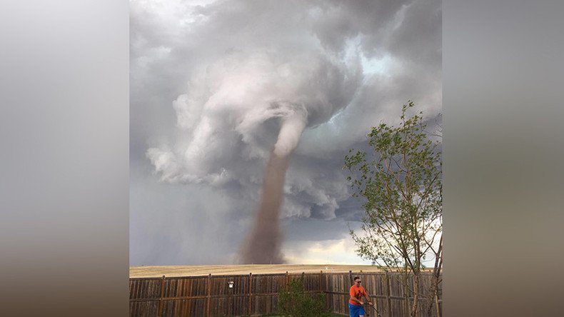 Man pictured mowing lawn next to Tornado creates online storm (PHOTO)